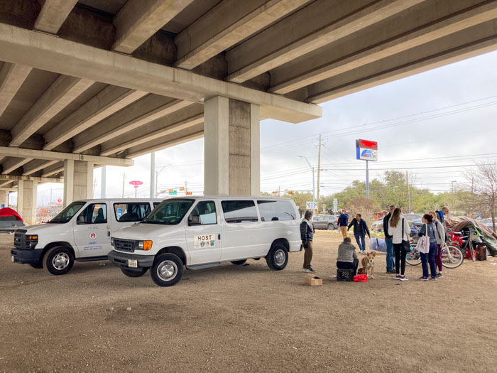 A total of 60 people move from an encampment at Pack Saddle Pass and US Highway 71 to temporary bridge shelters as part of the Housing-Focused Encampment Assistance Link (HEAL) Initiative.