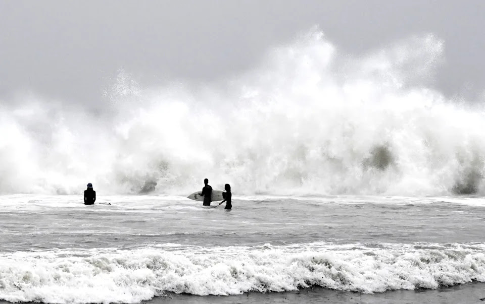 Surfers brave the waves during a rain storm at Venice Beach in Los Angeles on Saturday, Jan. 14, 2023. (Keith Birmingham/The Orange County Register via AP)