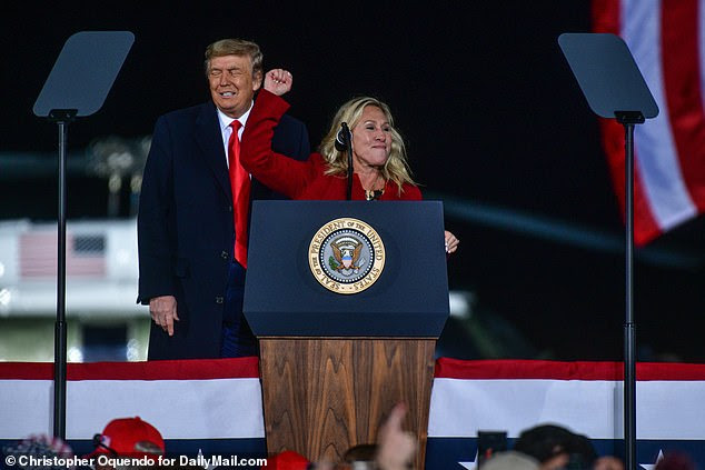 Rep. Marjorie Taylor Green (center) previously appeared alongside President Donald Trump (left) at a Dalton, Georgia rally on January 4 on behalf of two Republicans senators who lost their run-off races the next day to Democrats Jon Ossoff and Rev. Raphael Warnock