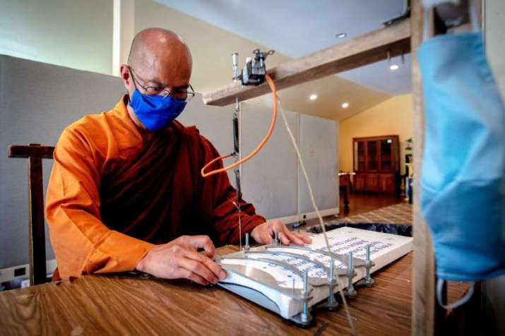 Ven. Quangtri Thich at work creating headbands at Phat Tue Temple in Riverside, California. From pe.com