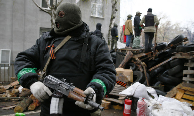 Un hombre armado vigila en el exterior de la comisaría de Slaviansk tomada por los prorrusos. 13 de abril de 2013. REUTERS/Gleb Garanich