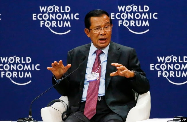 FILE - Prime Minister Hun Sen of Cambodia gestures as he talks about his vision for the Mekong region in the World Economic Forum on ASEAN at the National Convention Center in Hanoi, Vietnam, Sept. 12, 2018.