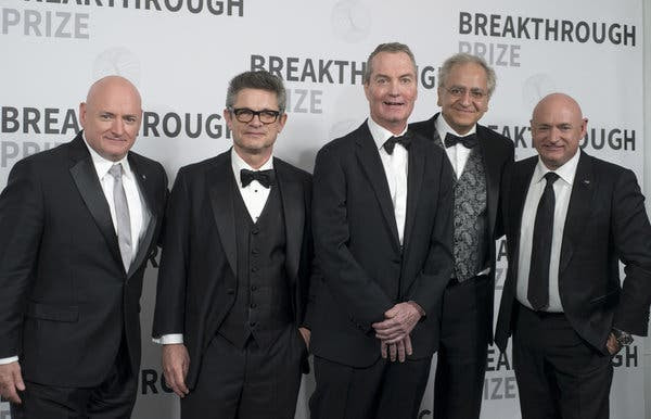 Joseph Polchinski, center, at the NASA Ames Research Center in Mountain View, Calif., with other winners of the 2017 Breakthrough Prize in Fundamental Physics: the physicists Andrew Strominger, second from left, and Cumrun Vafa, second from right. At the far left and far right are the astronauts Scott Kelly and Mark Kelly (Scott’s twin brother), who presented the award.