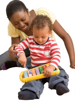 Toddler sitting with mom playing xylophone