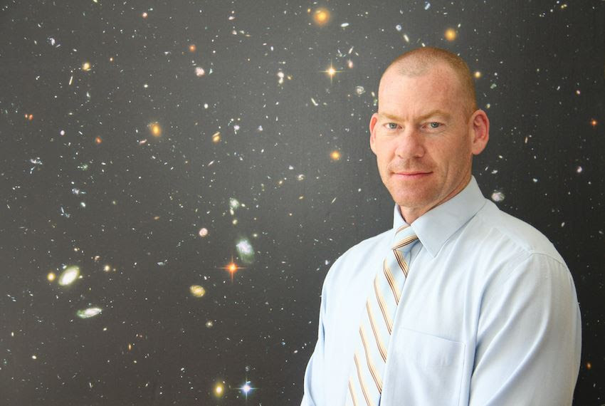 Professor Steven Tingay stands in front of a starfield
