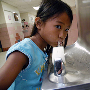 student drinking at
                                          school water fountain