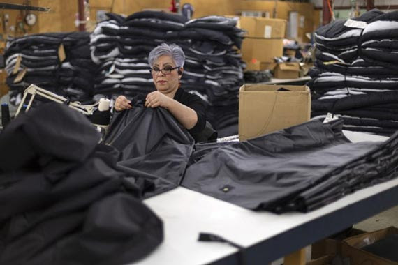 A female worker in Wiggy's factory sewing black material together to create a sleeping bag
