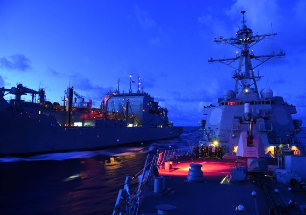 Steaming in the South China Sea USS Lassen (DDG-82), right, receives fuel from the Military Sealift Command dry cargo and ammunition ship USNS Amelia Earhart (T-AKE 6) during an underway replenishment. US Navy Photo