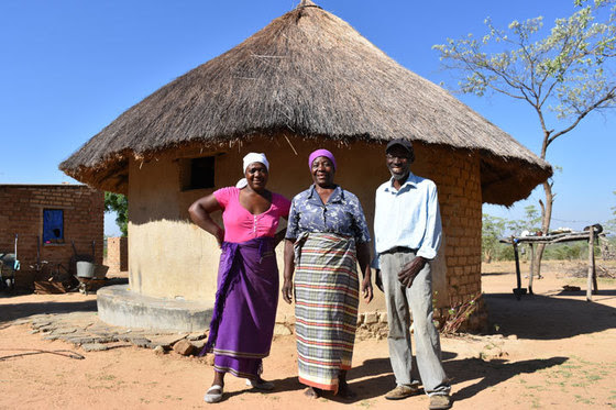 Three of six members of the Madzinga family pose at their homestead in the district of Mutoko in Zimbabwe.