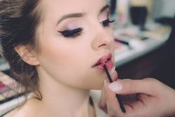 Woman putting on makeup