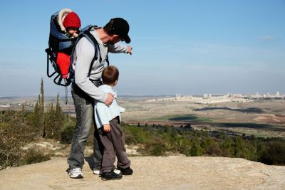 An Israeli father points out the family's
              hometown during a hike.
