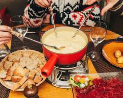 family enjoying a fondue in Switzerland