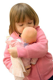 Toddler hugging doll