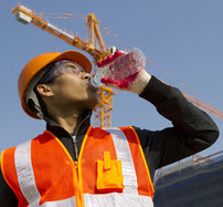 Construction worker drinking water