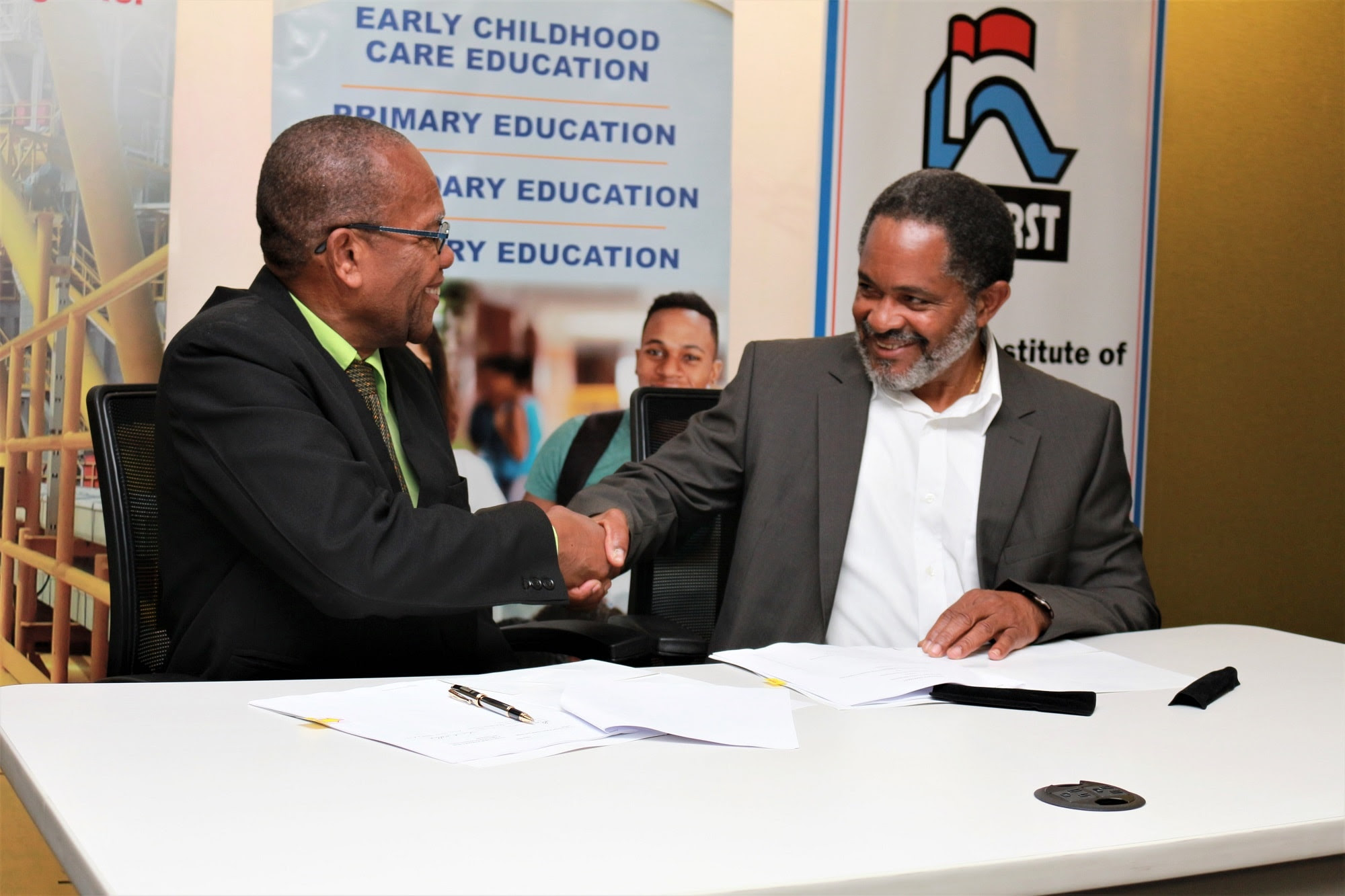 Ceremonial Signing between Professor Emeritus Winston Mellowes, Chairman of NIHERST (left) and Mr. Leslie Bowrin, External Relations Advisor, Shell (Right)