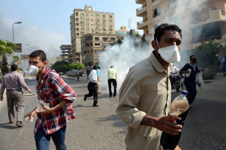 Egyptian Muslim Brotherhood supporters run from tear gas fired by police in Cairo in August 2013 during a police crackdown that the Brotherhood said killed hundreds of the group’s supporters. President Donald Trump’s administration is considering designating the Brotherhood as a terrorist organization. 