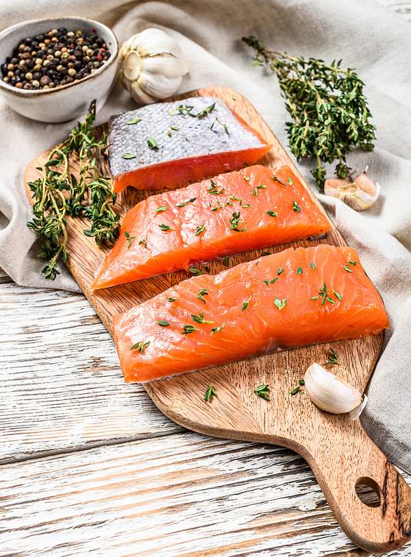 salmon portions on a wooden board