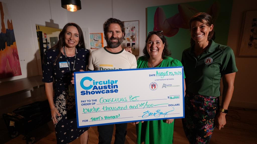 Mason Arnold (second from left) accepts the cash prize at the Circular Austin Showcase from Meghan Doherty (left), Tara Levy and Maddie Morgan.