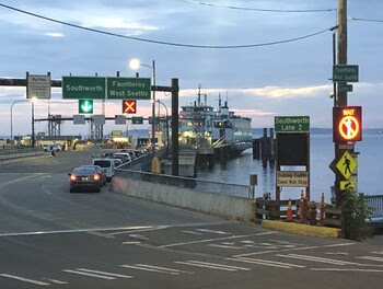 Vehicle entrance to dock at Vashon terminal with lighted electronic signs