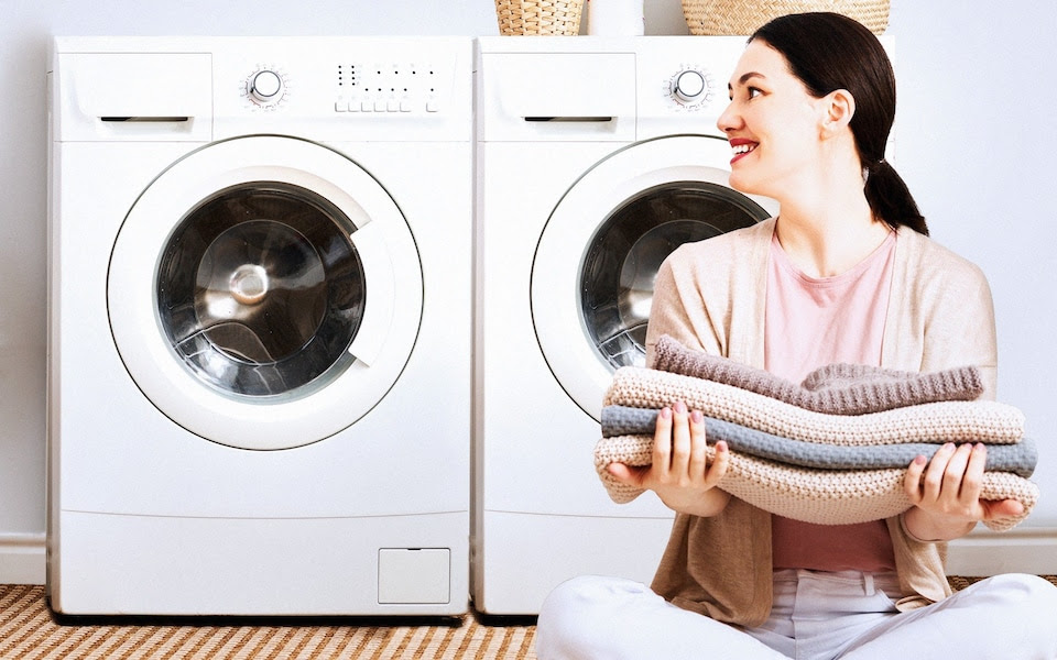 A woman pictured with two washing machines