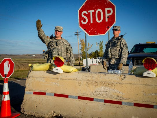 North Dakota National Guardsmen control traffic Sunday,