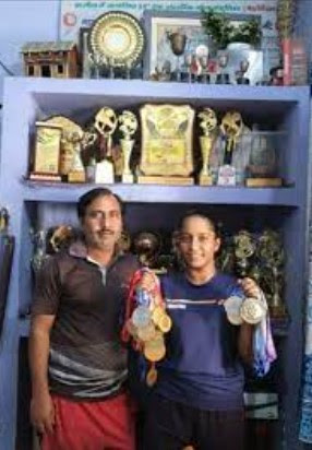 Aditya Yadav posing with her father and accolades