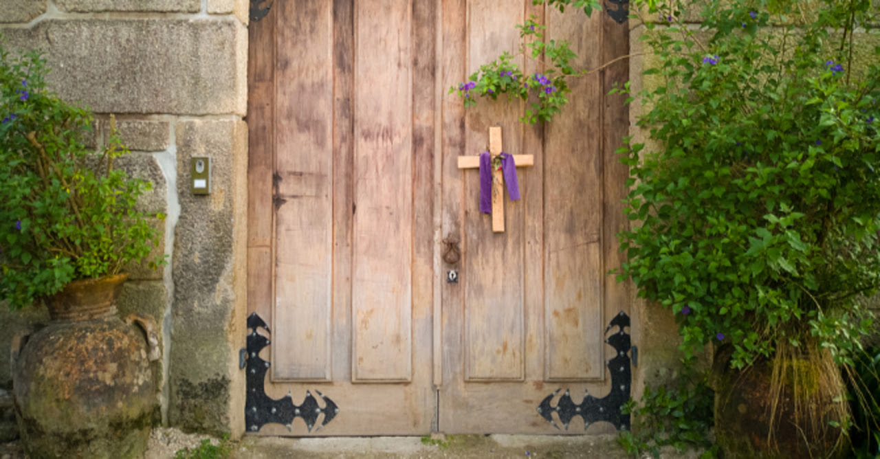 Cross draped in purple on a closed church door