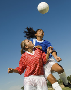 Girls Heading Soccer Ball During Match Girls Heading Soccer Ball During Match