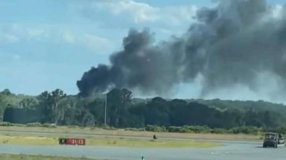 Smoke billows from the spot where a firefighting helicopter crashed