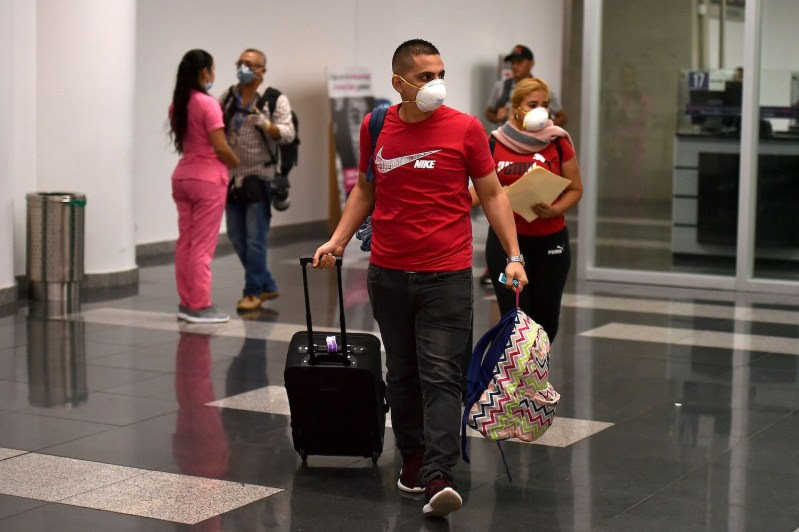 People wear protective face masks as a preventative measure against the spread of the coronavirus.