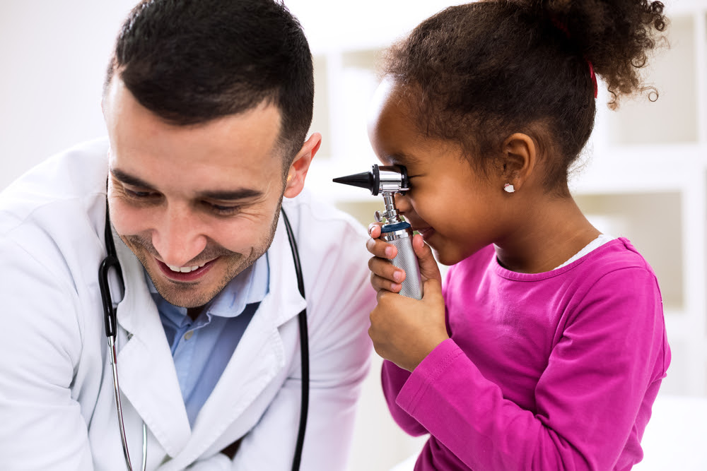 child looking in a doctors ear with otoscope