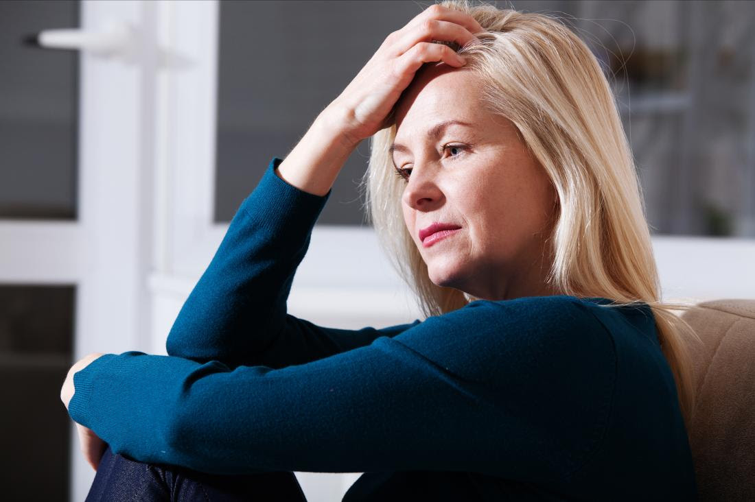 a woman looking stressed at home.