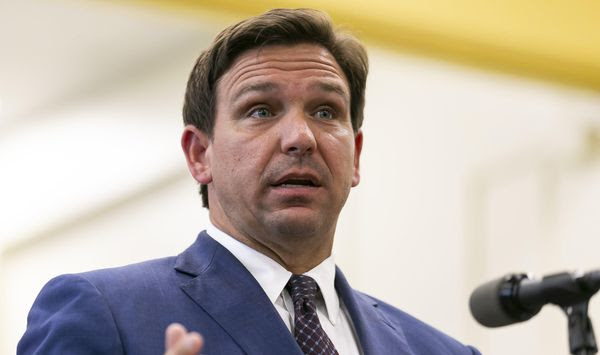 Florida Gov. Ron DeSantis, center, speaks during a news conference at West Miami Middle School in Miami on Tuesday, May 4, 2021. (Matias J. Ocner/Miami Herald via AP) ** FILE **