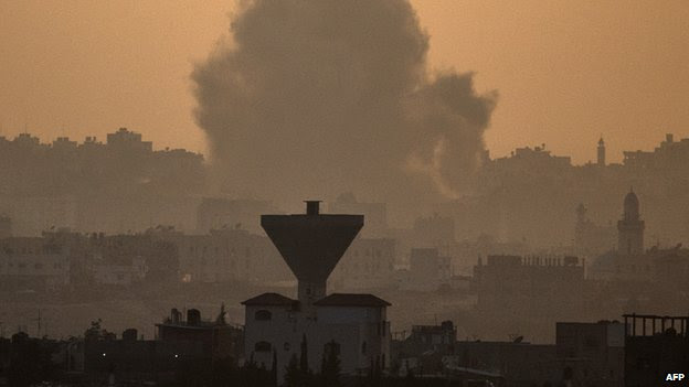 A picture taken on 20 July 2014, from the southern Israeli-Gaza border shows smoke billowing from buildings following an Israeli air strike on Gaza City.