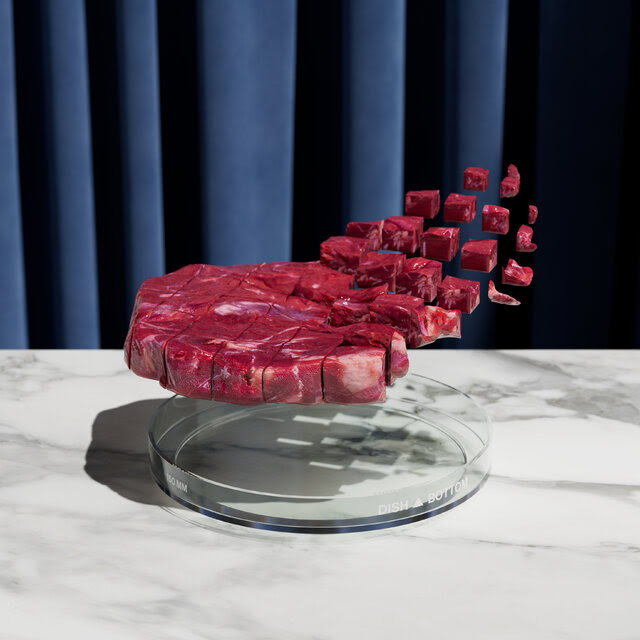 A photographic illustration showing a steak assembling itself out of tiny cubes, all hovering above a Petri dish.