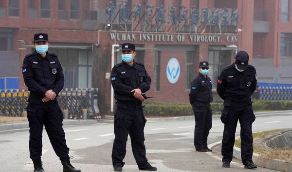 Security personnel manned the entrance of the Wuhan Institute of Virology during a visit this week by a team from the World Health Organization. (Associated Press) ** FILE **