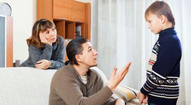 Picture of parents talking to their daughter about her behavior. 