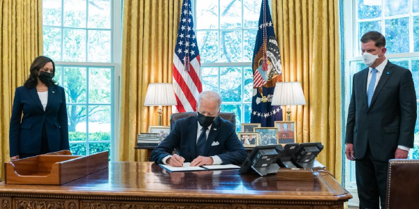 President Biden signs an executive order creating the White House Task Force on Worker Organizing and Empowerment while co-chairs Vice President Kamala Harris and Labor Secretary Marty Walsh look on. 