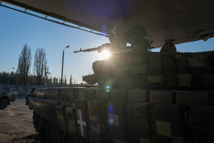 A Ukrainian tank sits under covering in the Kharkiv district of Ukraine