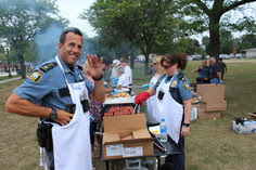Safe Summer Nights police officer standing at the grill