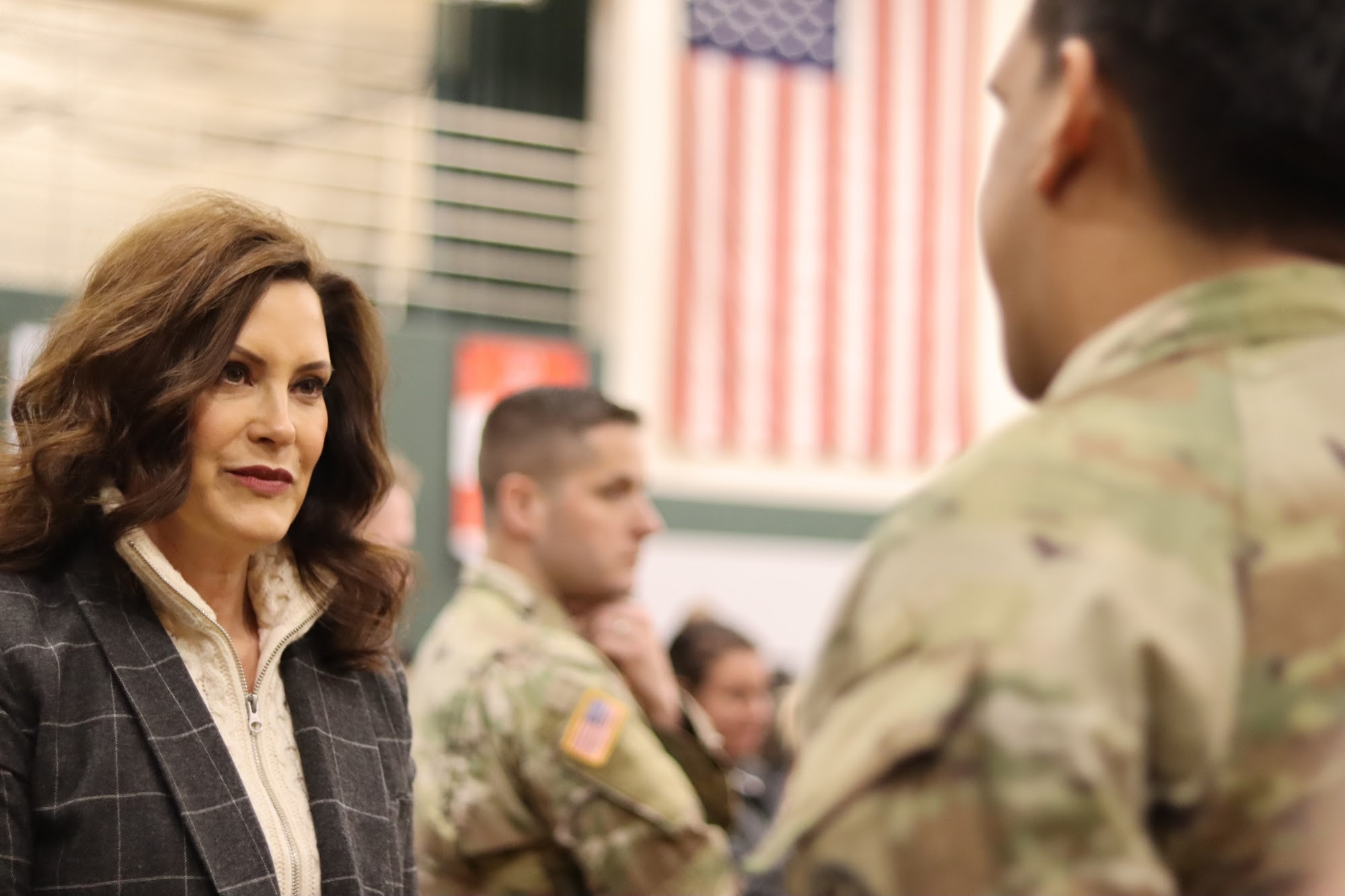Gov. Whitmer speaks with soldiers at the deployment ceremony 
