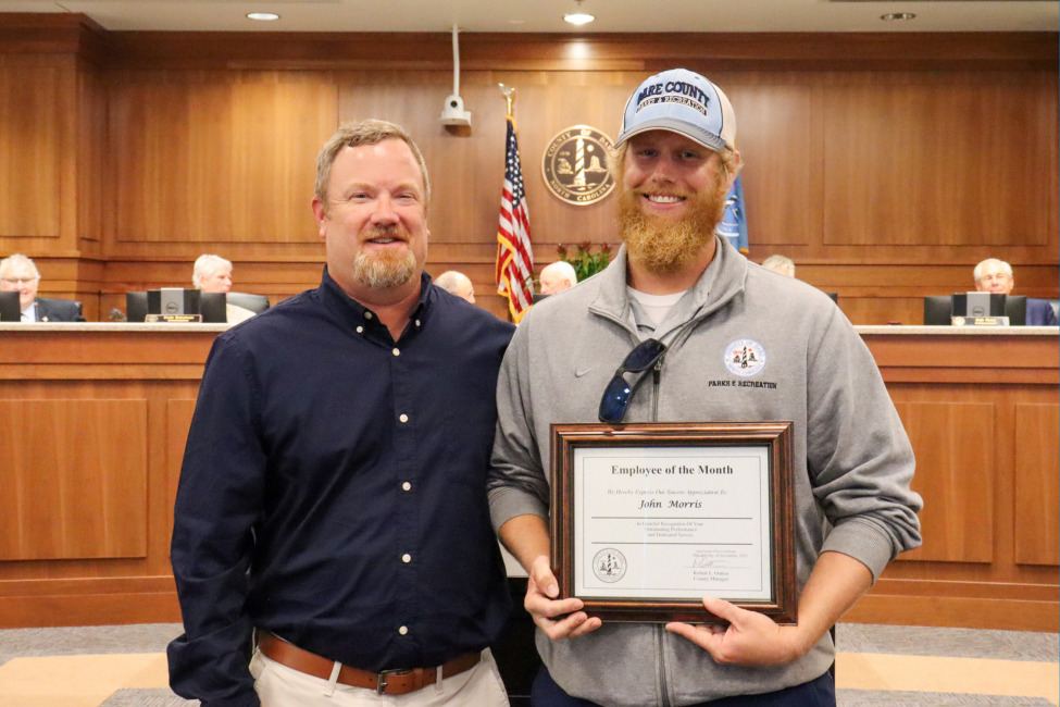 Spencer Gregory presents the November 2023 Employee of the Month award to John Morris.