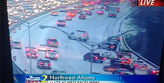 television screen showing news coverage of Atlanta snowstorm