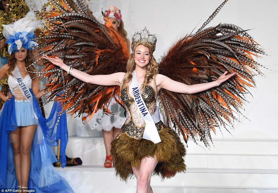 Miss Argentina Helena Zuiani went all out with the bird look, giving herself wings made of orange, brown and grey and white striped feathers, and an ostrich-like plume skirt. Helena's look was completed with a jewelled bodice and crown.