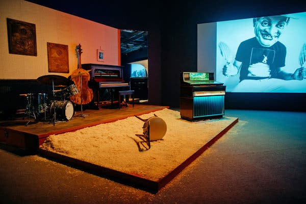 Three replicas of stages, including the one at Slugs’ Saloon, above, dominate the exhibition’s main gallery. Large screens show videos and stills from Mr. Moran’s collaborations.