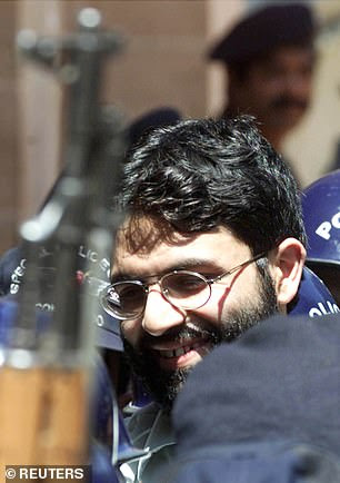 British-born Islamic militant Ahmed Omar Saeed Sheikh is surrounded by armed police as he arrives at a court in Karachi, Pakistan March 29, 2002