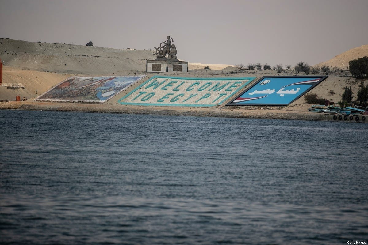 A "Welcome to Egypt" sign can be seen across the Suez Canal on 30 March 2021 in Ismailia, Egypt. [Mahmoud Khaled/Getty Images]