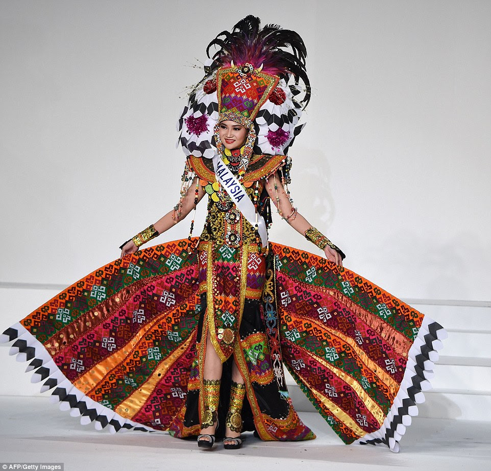 Miss Malaysia was all about the textiles, wearing a heavily embroidered multi-coloured dress lined with gold. The aptly named Immaculate Lojuki dangled with coloured beads as she held out the wings to her skirt, the width balanced by samurai-eque shoulder pads and a flamboyant headdress with feathers and black and white flowers with sparkly pollen 