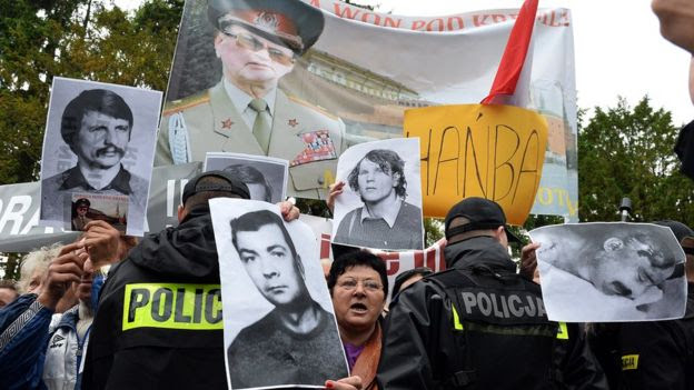 Protestors holding pictures of Gen Wojciech Jaruzelski' Martial Law
