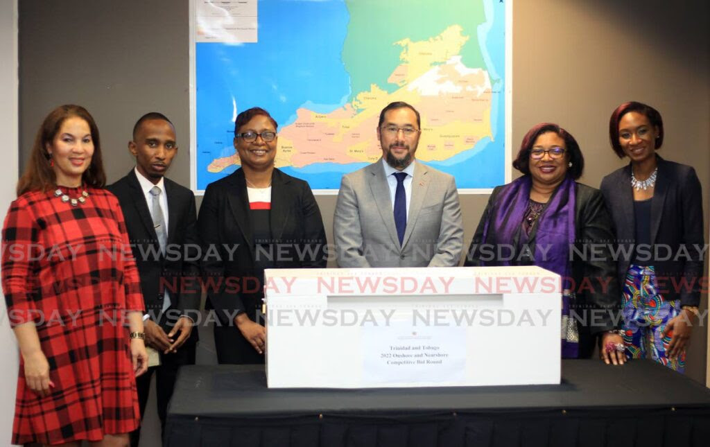 Minister of Energy Stuart Young, centre, and, from left, senior state counsel Louise Poy Wing, senior geologist Keon Dube, Ministry of Energy permanent secretary Penelope Bradshaw-Niles, Ag PS Sandra Fraser and senior geologist Kimberlee London, stand behind the white box containing the bid entrees for Trinidad and Tobago Onshore and Nearshore Competitive Bid Round 2022, at the ministry at the International Waterfront Centre, in Port of Spain on Monday. Photo by Roger Jacob